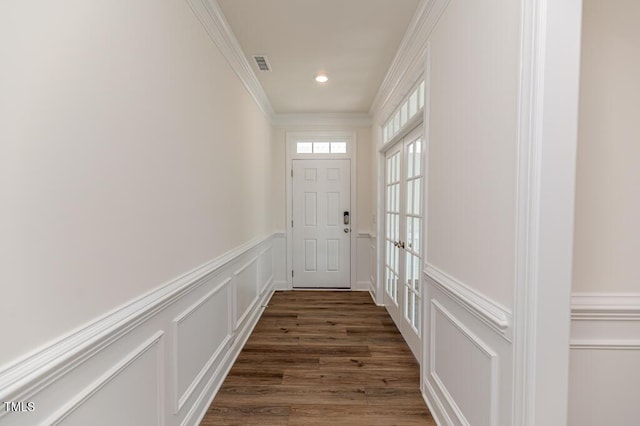 entryway featuring ornamental molding and dark hardwood / wood-style floors