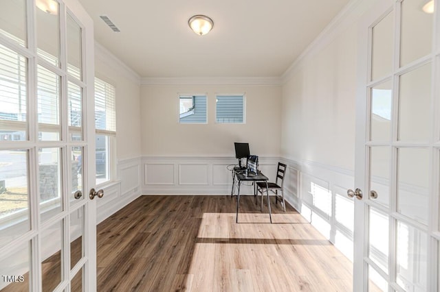 unfurnished office featuring ornamental molding, french doors, and wood-type flooring