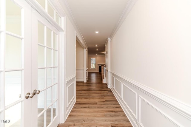 corridor featuring hardwood / wood-style flooring, french doors, and crown molding