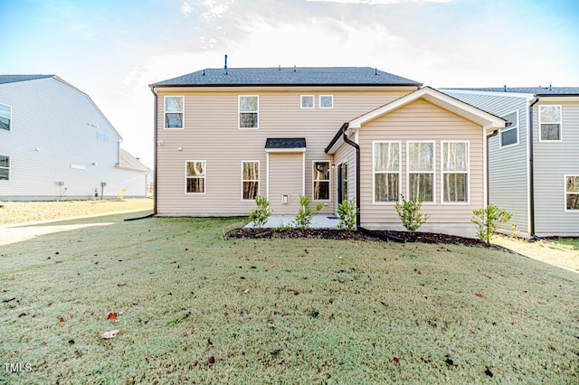 back of property featuring a yard and a patio