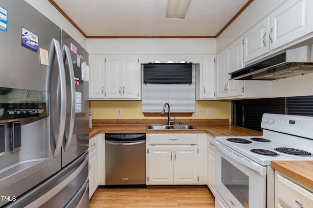 kitchen with under cabinet range hood, crown molding, appliances with stainless steel finishes, and a sink