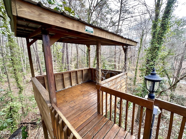 wooden deck featuring a view of trees