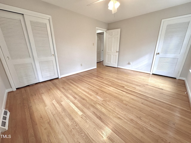 unfurnished bedroom with light wood-style flooring, visible vents, baseboards, and ceiling fan