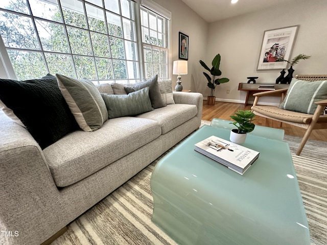 living area with recessed lighting, wood finished floors, and baseboards