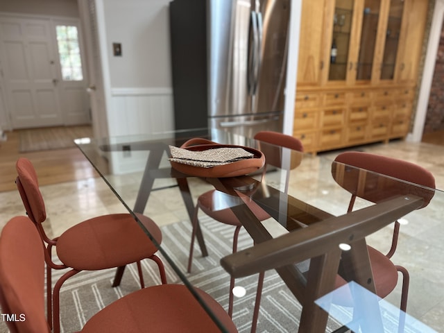 dining area with a decorative wall and wainscoting