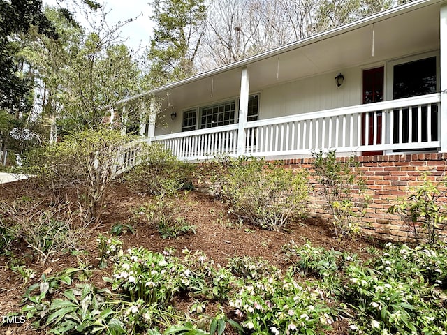 view of side of property featuring a porch