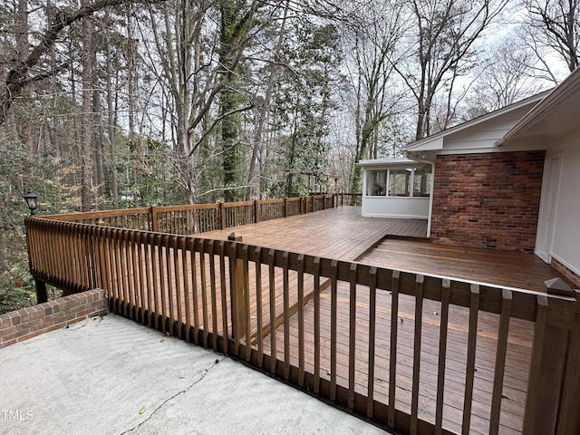 wooden deck featuring a sunroom