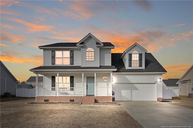 view of front of home with covered porch, cooling unit, and a garage