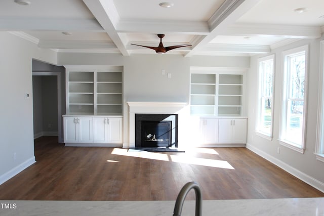 unfurnished living room with ceiling fan, beam ceiling, and coffered ceiling