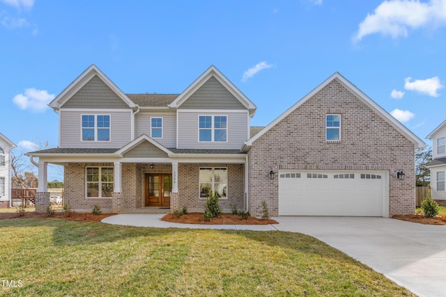 craftsman house with a garage, brick siding, driveway, and a front lawn