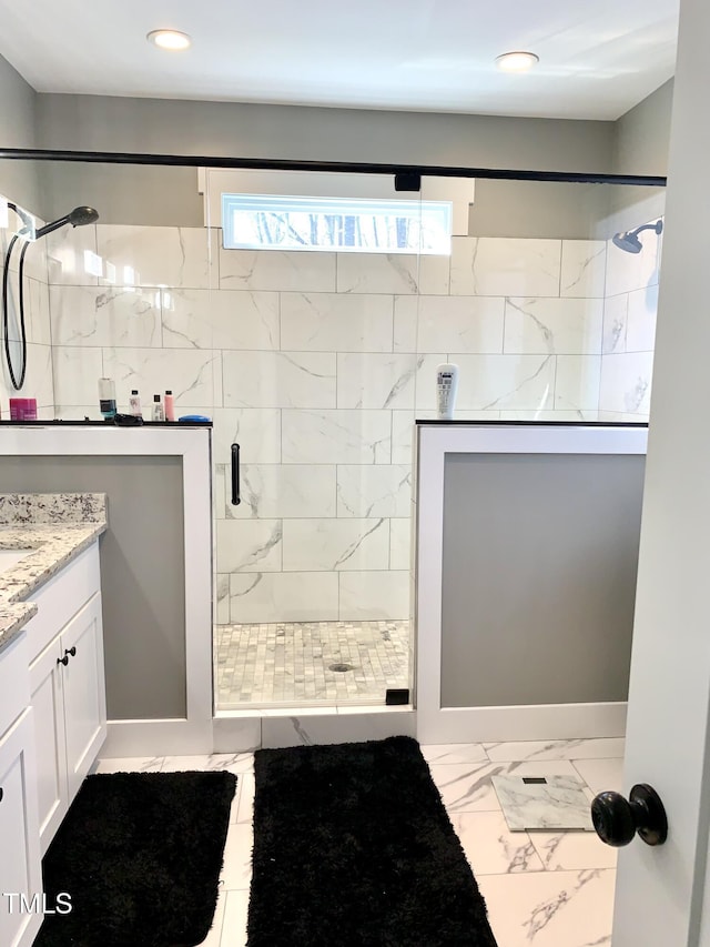 bathroom featuring an enclosed shower and vanity