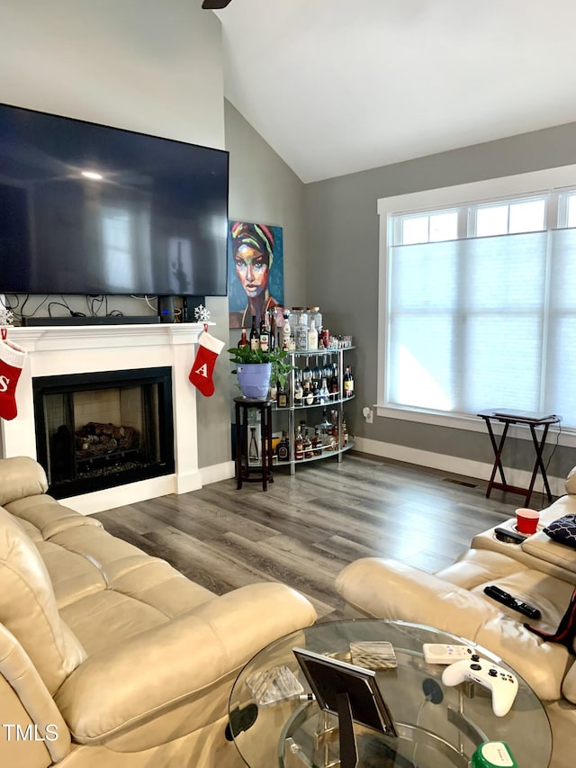 living room featuring hardwood / wood-style flooring and lofted ceiling