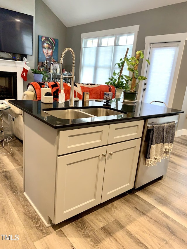 kitchen with white cabinets, sink, and light hardwood / wood-style floors