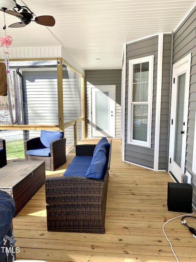 wooden deck featuring ceiling fan and outdoor lounge area