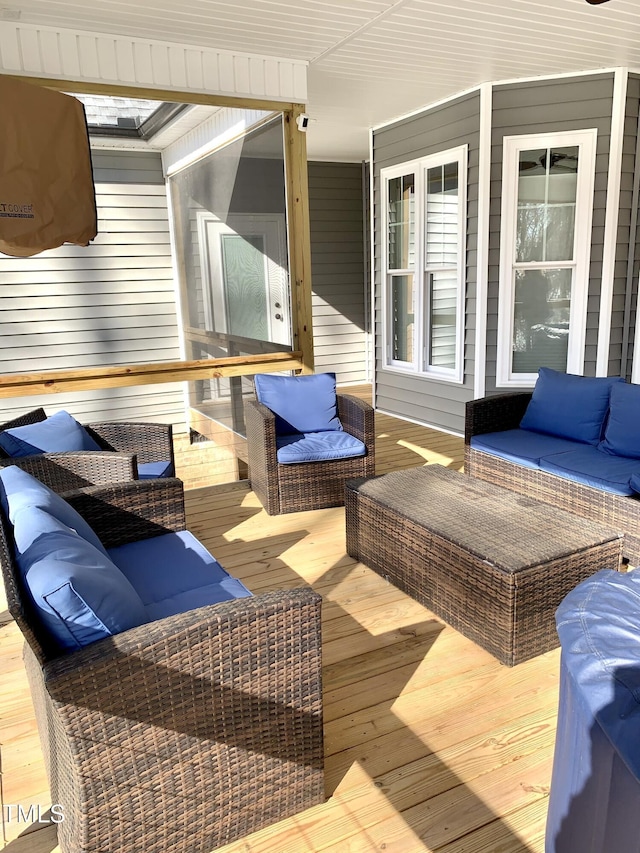 wooden terrace with an outdoor hangout area