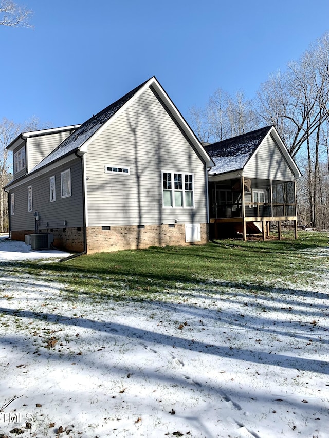 back of property featuring a sunroom, a yard, and central air condition unit