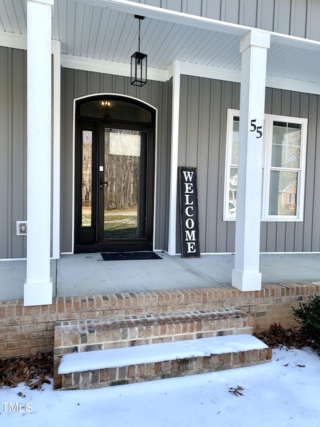 view of snow covered property entrance