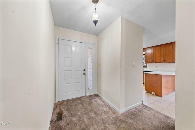 foyer featuring light carpet