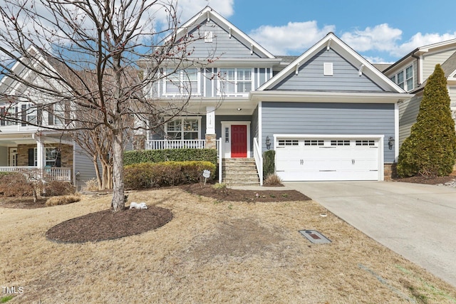 craftsman inspired home featuring concrete driveway, a garage, and covered porch