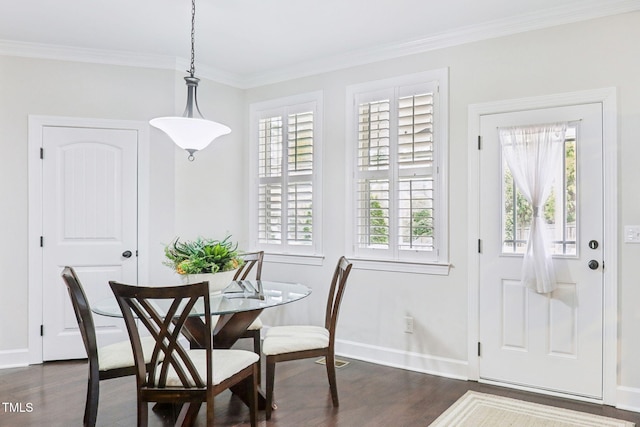 dining room featuring baseboards, dark wood finished floors, and crown molding