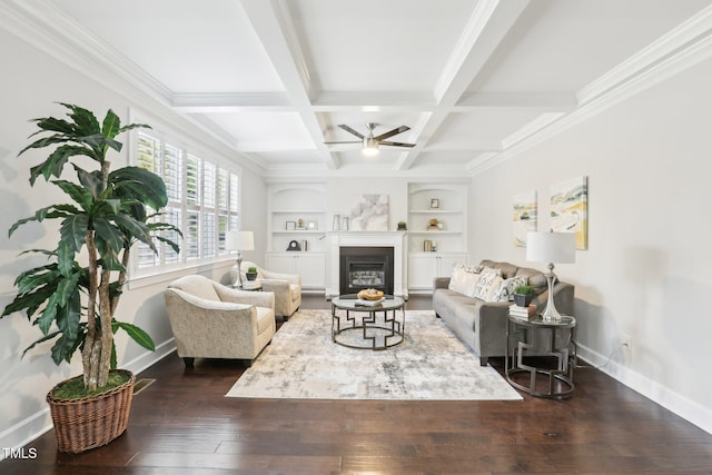 living area featuring coffered ceiling, baseboards, ceiling fan, and dark wood-style flooring