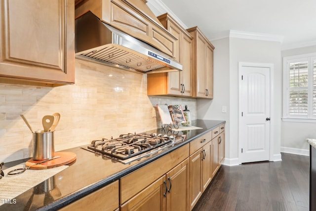 kitchen with baseboards, dark wood-style flooring, ornamental molding, wall chimney range hood, and tasteful backsplash