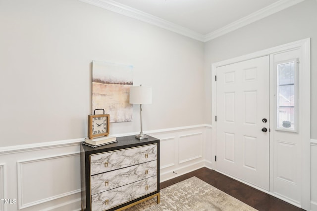 entryway featuring a decorative wall, a wainscoted wall, crown molding, and dark wood-style flooring