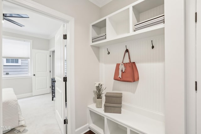 mudroom with baseboards and carpet