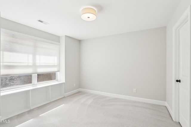 empty room with visible vents, baseboards, and carpet floors