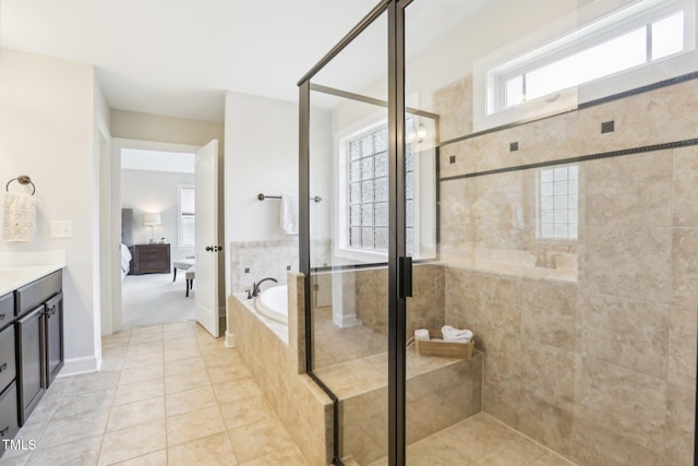 bathroom featuring a stall shower, ensuite bath, tile patterned flooring, a bath, and vanity