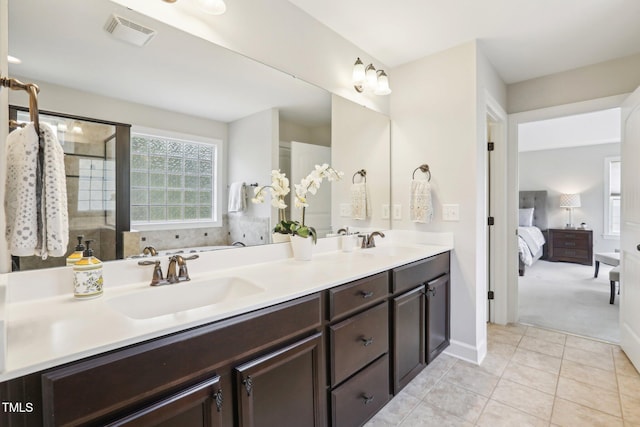 bathroom with tile patterned floors, double vanity, visible vents, and a sink