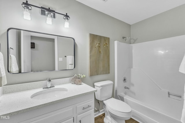 full bathroom featuring toilet, shower / washtub combination, vanity, and hardwood / wood-style flooring