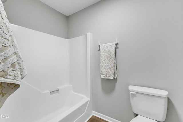 bathroom featuring toilet, shower / bathing tub combination, and wood-type flooring