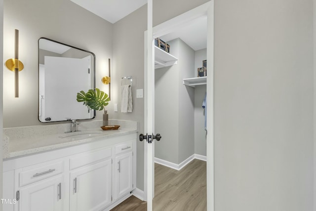 bathroom with vanity and hardwood / wood-style flooring