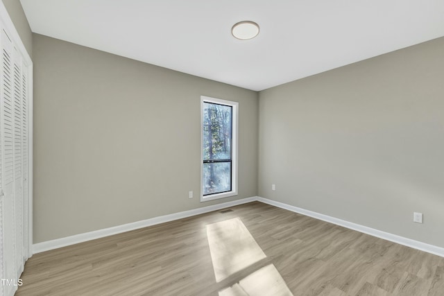 spare room with light hardwood / wood-style flooring