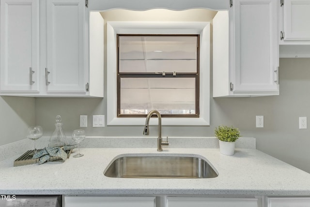 kitchen with sink, white cabinetry, dishwasher, and light stone counters