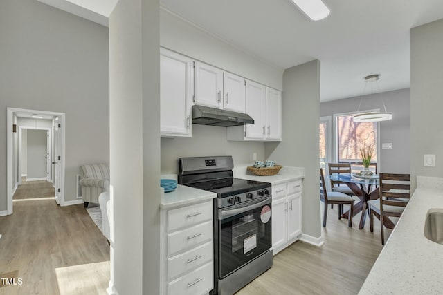 kitchen with light hardwood / wood-style floors, stainless steel range with electric stovetop, light stone counters, white cabinetry, and decorative light fixtures