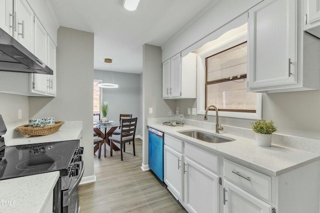 kitchen featuring sink, white cabinets, light wood-type flooring, pendant lighting, and appliances with stainless steel finishes