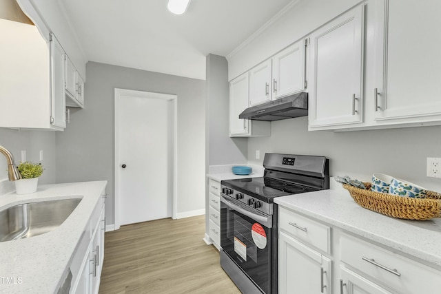 kitchen with stainless steel range with electric cooktop, sink, white cabinets, light wood-type flooring, and light stone countertops