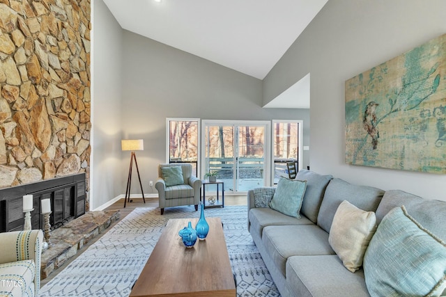 living room with high vaulted ceiling, a fireplace, and wood-type flooring