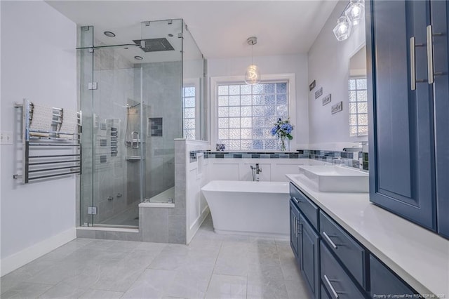 bathroom with backsplash, tile patterned flooring, separate shower and tub, and vanity