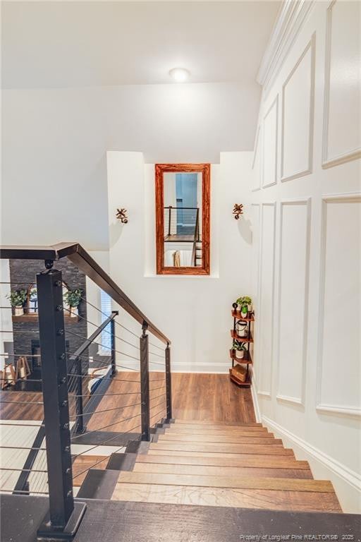 stairway with hardwood / wood-style flooring