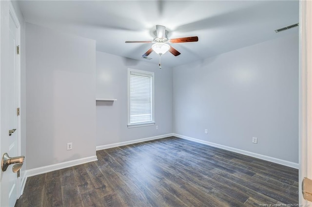 spare room featuring ceiling fan and dark hardwood / wood-style floors