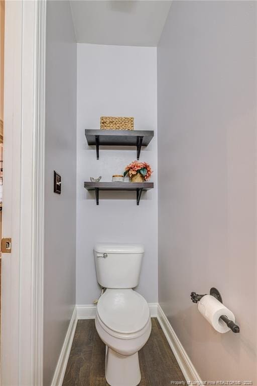 bathroom with toilet and hardwood / wood-style floors