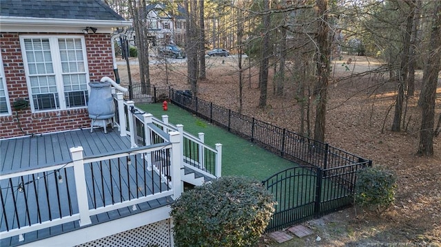 wooden terrace featuring a yard