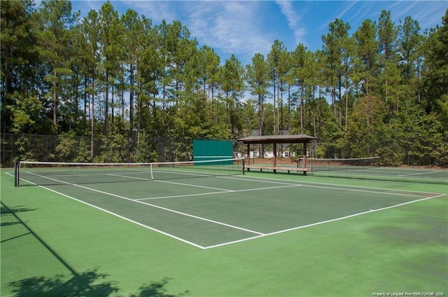 view of tennis court featuring basketball court and a gazebo