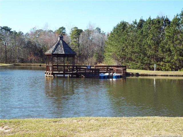 view of dock with a gazebo and a water view