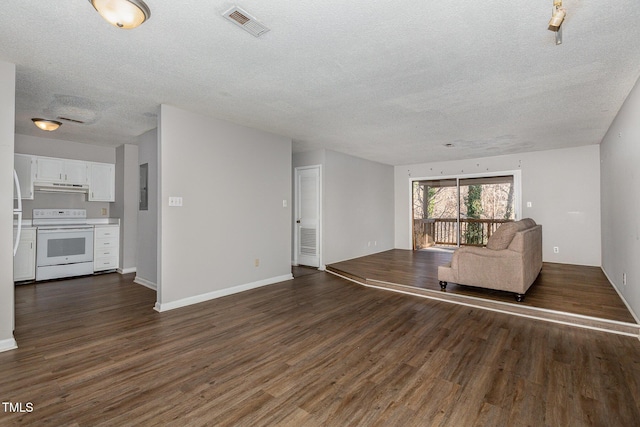 unfurnished living room with a textured ceiling and dark hardwood / wood-style flooring