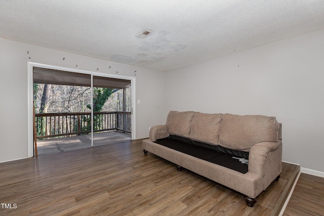 living area featuring a textured ceiling and wood-type flooring