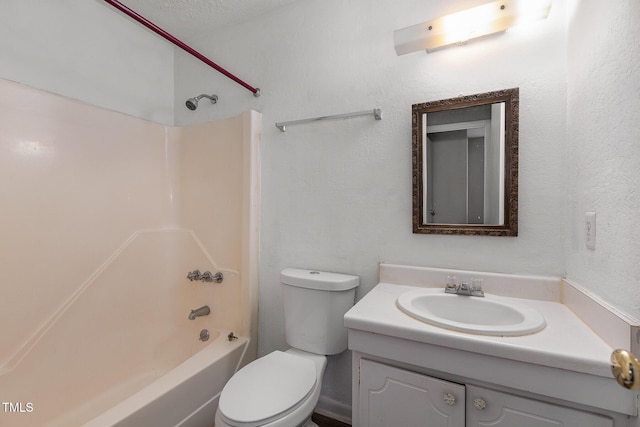 full bathroom with toilet, vanity, a textured ceiling, and  shower combination